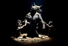 an image of a statue that looks like it is sitting on the ground in the dark