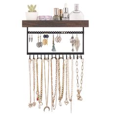 a wall mounted jewelry rack with lots of necklaces