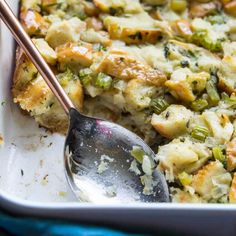 a casserole dish with broccoli, cheese and other toppings in it