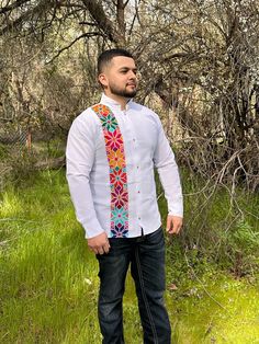 This Guayabera Shirt is a Traditional Mexican Shirt that never goes out of style. It's Stylish, Fresh and Comfortable. This Elegant Collared shirt is perfect for everyday use, Vacation and or any Special occasion. White Long sleeve with Multicolored embroidery Stripe detail. Keep in mind these are hand made so embroidery colors may vary. - Made in Mexico  - Elegant Shirt We are not responsible for Stolen, late or Lost packages due to mail carriers. Message us if you have any questions. * More Guayaberas styles Avaible click links to view. https://www.etsy.com/CositasBonitasByAri/listing/1429673383/guayabera-men-long-sleeve-mexican-shirt?utm_source=Copy&utm_medium=ListingManager&utm_campaign=Share&utm_term=so.lmsm&share_time=1677962341769 https://www.etsy.com/CositasBonitasByAri/listing/141 White Long Sleeve Shirt For Festival, Traditional White Button-up Shirt, Guayabera Hombre Outfit, Bruno Costume, Mexican Wedding Party, Traditional Mexican Shirts, Mexican Shirt, Hispanic Men, Mexican Shirts