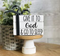 a wooden sign that says home sweet home on top of a table next to a potted plant