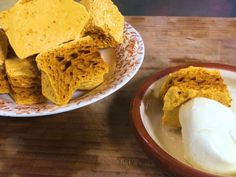 a plate with some food on it next to a bowl full of cornbreads