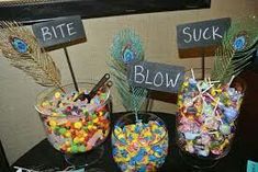 three glass vases filled with candy sitting on top of a table next to each other