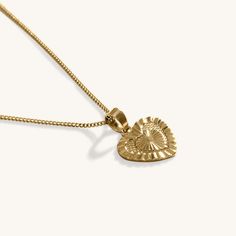 Our 18k Gold Heart Pendant Necklace features an gorgeous delicate chain, coupled to an intricately designed Heart pendant. This chain pairs beautifully with other chain necklaces or pendants. Perfect for day or night, this necklace is perfect for any occasion. When you're not wearing this piece, tuck it away in your very own Milou jewellery box provided. Stainless Steel, plated with 18K Gold Chain Length: 50cm Pendant Width: 2cm Waterproof (Tarnish Resistant) Natural Linen Milou Jewellery Box In Delicate Heart Pendant Necklace, Delicate Tarnish Resistant Heart Pendant Necklace, Elegant Pendant Charm Necklace With Heart Detail, Heart Pendant Necklace Tarnish Resistant As Gift For Her, Gold Plated Heart Pendant Necklace Tarnish Resistant, Elegant Heart Pendant Charm Necklace, Gold Plated Heart Pendant Necklace, Tarnish Resistant Heart Pendant Necklace As Gift For Her, Tarnish Resistant Heart Pendant Necklace For Her