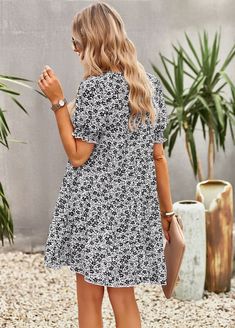 Celebrate the warm weather with the Lilacoo Chiffon Floral Dress. The lightly textured satin material features a beautiful floral print, creating a fresh and breezy look. The dress falls from a scoop neck and back (with tying detail at the back) into short dolman sleeves with drop shoulders and folded cuffs, adding a touch of sophistication to the dress. The seamed, wide-cut bodice tops an empire waist and flared mini skirt, creating an on-trend babydoll silhouette. Let your outfit speak for its Casual Chiffon Floral Dress With Short Sleeves, Casual Short Sleeve Chiffon Floral Dress, Casual Chiffon Floral Dress For Day Out, Chiffon Floral Dress, Sleeveless Dresses Casual, Flared Mini Skirt, Bodice Top, Floral Chiffon Dress, Chiffon Floral