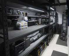 the inside of a garage with shelves and tools