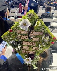 a woman wearing a graduation cap with words written on it