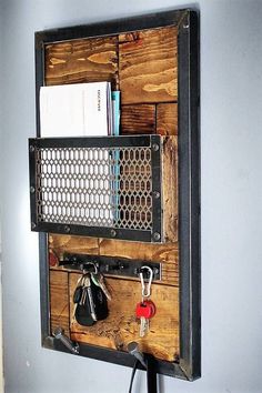 a wooden wall mounted shelf with keys and other items on it's sides, attached to the wall