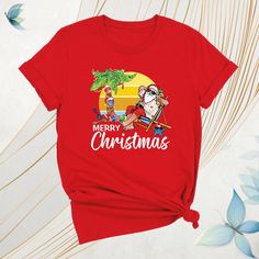 Mele Kalikimaka Christmas Shirt, Merry Hawaiian Santa Christmas Shirt, Beach Xmas Team Tee, Tropical Christmas Shirt, Coastal Party Xmas Tee Celebrate the season island-style with our Mele Kalikimaka Christmas Shirt! This festive Merry Hawaiian Santa Christmas Shirt brings tropical vibes to your holidays. Perfect for a Beach Xmas Team Tee or a fun Tropical Christmas Shirt at your next coastal party. Whether you're looking for a Santa Christmas Tee or a unique Coastal Party Xmas Tee, this Kalikimaka Christmas Shirt adds a Hawaiian twist to your Christmas celebrations. Ideal for holiday gatherings, this Island Christmas Tee is your go-to Christmas Party Tee for 2024! Mele Kalikimaka Christmas Shirt: How To Order: - Please, check all tees color and  size charts. - Select your shirt size, colo Hawaiian Santa, Coastal Party, Island Christmas, Hawaii Style, Tropical Christmas, Xmas Tees, Mele Kalikimaka, Santa Shirts, Xmas Shirts