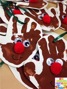 paper plates with handprinted reindeer faces on them