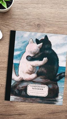 a greeting card with an image of a cat and dog hugging each other on top of a rock