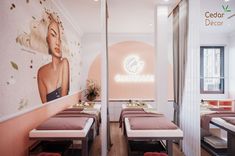 the interior of a beauty salon with two tables and chairs in front of a wall mural