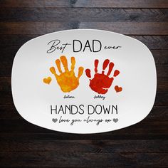 a plate with two handprints on it and the words best dad ever written