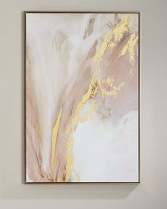 an abstract painting hangs on the wall next to a white chair and table in front of it