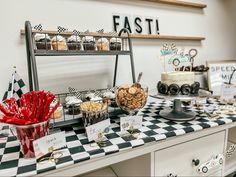 an assortment of desserts and pastries on a checkered tablecloth at a race themed birthday party