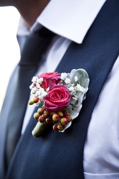 a man in a suit with a boutonniere on his lapel