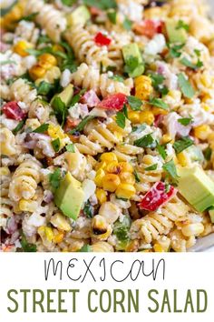 a white bowl filled with pasta salad and topped with avocado