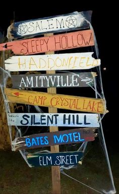 a wooden sign with many different signs on it