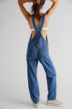 So essential and forever timeless overalls from our We The Free collection. **Fit:** Relaxed, slouchy silhouette **Features:** Bib-and-brace design, tapered legs, exaggerated bib pocket detail, rigid denim fabrication, varied distressing throughout **Why We | We The Free Ziggy Denim Overalls at Free People in Medium Wash, Size: XS Birkenstock Clogs Outfit Fall, Long Jumpsuit Casual, Birkenstock Clogs Outfit, Clogs Outfit Fall, Womens Denim Jumpsuit, High Way, Denim Suspenders, Shirts And Skirts, Chic Fits