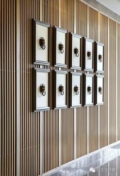 the wall is lined with metal and wood frames, which are mounted on wooden slats