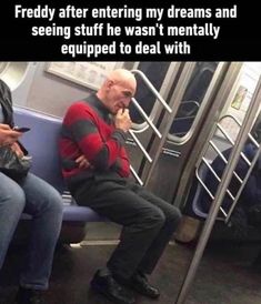 two people sitting on a subway train next to each other and one person holding a cell phone