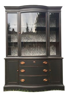 an old china cabinet with glass doors and drawers on top, in front of a white background