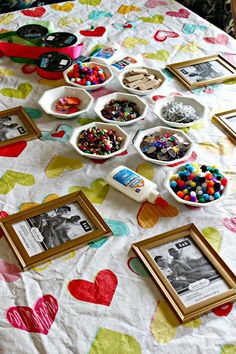 a table topped with pictures and bowls filled with candy