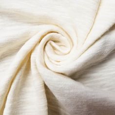 a close up view of the fabric on a white shirting material that is very soft