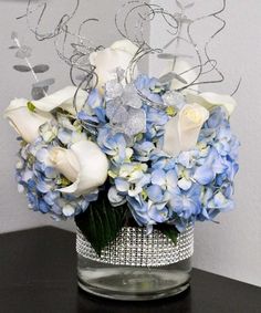 a vase filled with blue and white flowers