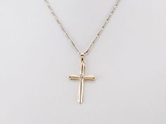 This diamond cross is the perfect everyday piece and would make a great First Communion or Confirmation gift! Crafted of both yellow and white gold, this stately pendant is set with a diamond accent at the center for a look that is special without being ostentatious. This pendant does not come with the chain shown. Please feel free to contact us, we will help you find the perfect chain for your style and budget! Metal: 14K Yellow and White Gold Gem: Diamond Gem Measurements: 0.8 mm, Round Measur Formal Yellow Gold Cross Necklace With Diamond Accents, Formal Yellow Gold Diamond Cross Necklace, Yellow Gold Cross Pendant Necklace With Diamond Accents, Yellow Gold Pendant Cross Necklace With Diamond Accents, Yellow Gold Cross Necklace With Diamond Accents, Yellow Gold Cross Necklace With Brilliant Cut, Yellow Gold Brilliant Cut Cross Necklace, Gold Cross Pendant Necklace With Brilliant Cut, Gold Cross Necklace With Brilliant Cut