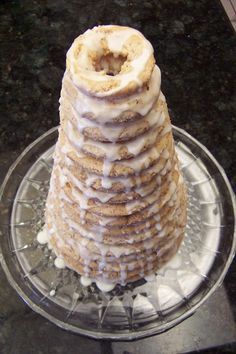 a stack of donuts sitting on top of a glass plate