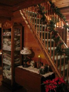 the stairs are decorated with garland and poinsettis