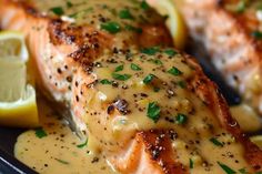 grilled salmon with mustard sauce and lemon wedges