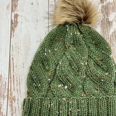 "This knit cable beanie is the perfect cool weather accessory.   Handmade with an acrylic blend for easy care and comfort.  Crafted in a green tweed to add a pop of color your winter wardrobe. Machine washable. Knit in the round without seams and brim is folded for extra warmth.    Measurements: 8\" x 19\" (unstretched)  One size fits most Ready to ship!" Fur Pom Pom Beanie, Pom Pom Beanie Hat, Green Tweed, Knit In The Round, Wool Beanie, Winter Hats For Women, Faux Fur Pom Pom, Bulky Yarn, Pom Beanie