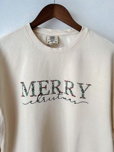 Floral, delicate, beautiful; These new lightweight Comfort Colors crewnecks are my absolute favorite! These ivory Comfort Colors sweatshirts are a NEW lightweight design! Comfort Colors sweatshirts are the fun and festive apparel that will make you the cutest and most colorful guest at your holiday sweater party! Jingle all the way in this crewneck! These make wonderful Christmas gifts too! This design is embroidered on an ivory Comfort Colors lightweight sweatshirt. This design is not customizable. This design and colors cannot be altered, resized, or changed. It is unisex sized. This means the sizing is boxy, not fitted like women's, but it is not oversized. Please reference the size chart provided. 6.4 oz./yd², 100% ring-spun cotton Garment-dyed for that lived in feel and almost no shri Christmas Crew Neck Sweatshirt With Embroidered Graphics, Christmas Embroidered Crew Neck Sweatshirt, Holiday Embroidered Crew Neck Sweatshirt, Embroidered Crew Neck Sweatshirt For Holiday, Festive Embroidered Crew Neck Top, White Christmas Tops With Embroidered Graphics, Crew Neck Top With Embroidered Text As Gift, Christmas Sweatshirt Ideas, Holiday Sweater Party