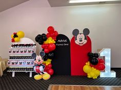 mickey mouse balloon decorations and balloons on display in an office setting for children's birthdays