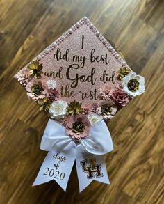 a pink and white graduation cap with flowers on the front that says, i did my best and god aid the rest