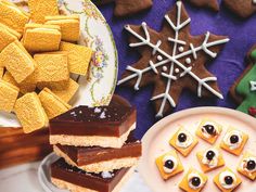 a table topped with lots of desserts and cookies