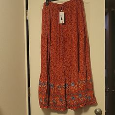 This Skirt Is A Long Maxi Style With A Beautiful Pattern On The Bottom. Brand New Never Worn. Red Maxi Skirt With Elastic Waistband For Beach, Red Casual Midi Skirt, Casual Red Midi Skirt, Red Midi Skirt With Elastic Waistband, Red Tiered Maxi Skirt With Elastic Waistband, Red Skirt With Elastic Waistband, Red Long Skirt For Vacation, Casual Red Long Skirt, Red Flared Maxi Skirt For Beach