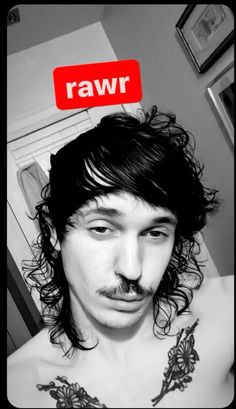 a man with long hair and a moustache has the word raw above his head