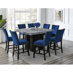 a dining room table with blue chairs around it