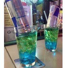 the irish trash can is filled with blue and green liquid, ice cubes, and vodka