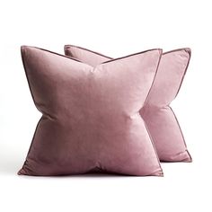 two pink pillows sitting on top of each other