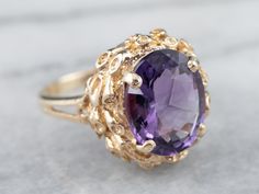 "This ring is truly gorgeous! A large and beautiful medium purple amethyst sits in the center, with an amazing cut and vibrant purple color that flickers with bright pops of violet! The stone is expertly cut to really display the stone's color and sparkle! The classic mid-century mounting is all this stone needs to frame it to perfection! Metal: 14K Yellow Gold Gem: Amethyst 3.70 Carats Gem Measurements: 12.0 x 9.8 mm, Oval Ring Size: 6.75 Marks: \"14K\" Stamped on the inside band SKU: 0KHZX8NN Elegant Purple Amethyst Ring With Large Stone, Yellow Gold Amethyst Ring, Amethyst Cocktail Ring, Gold Amethyst Ring, Right Hand Ring, Right Hand Rings, Hand Ring, Vibrant Purple, Oval Rings