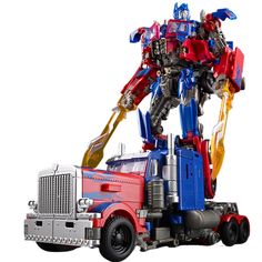 a red, white and blue toy truck with a large robot on it's back