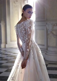 a woman in a white wedding dress standing on a checkered floor with her hands behind her back