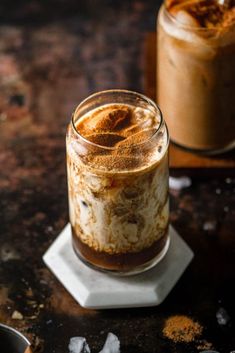 two jars filled with food sitting on top of a table