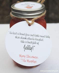 a jar filled with jam sitting on top of a white table next to a tag