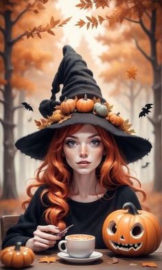 a woman wearing a witches hat sitting at a table with pumpkins and a cup