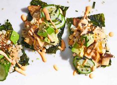 three pieces of broccoli topped with nuts and sauce